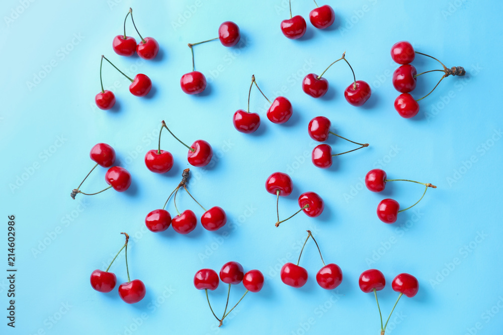 Flat lay composition with ripe cherries on color background Flat lay composition with ripe cherries on color background