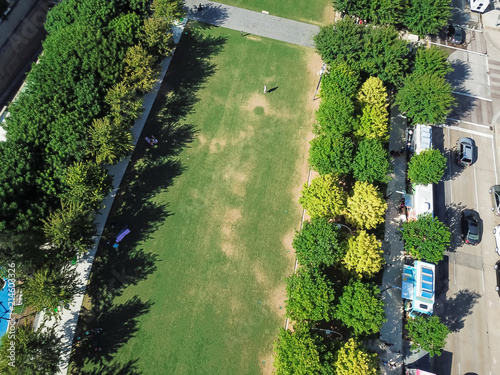 Aerial view green public park in downtown Dallas, Texas, USA in summer sunny day. Trees lush and grassy lawn for outdoor exercising, workout and recreation activities photo