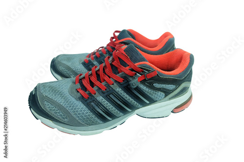 Used gray running shoes over a white background