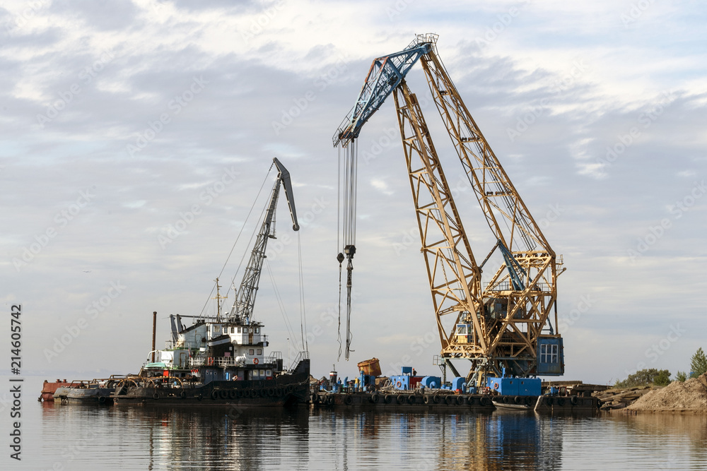 Floating cranes loaded goods on the water