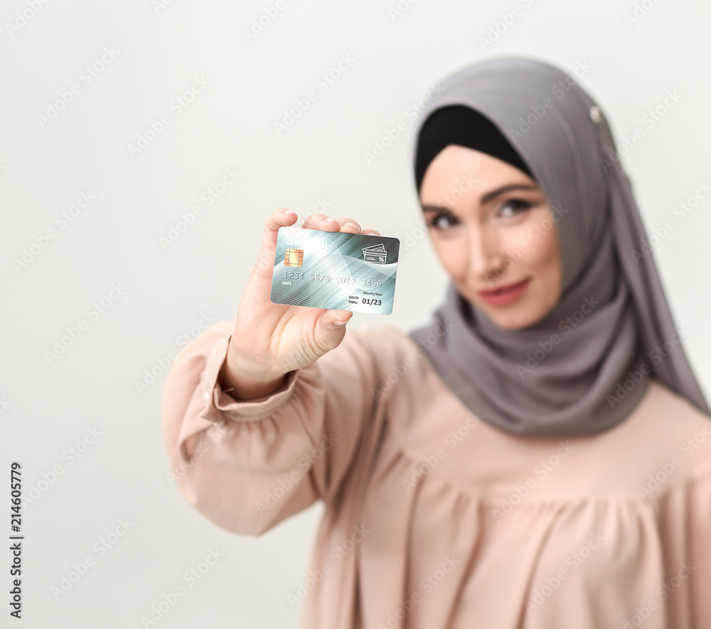 Arab woman showing credit card Arab woman showing credit card