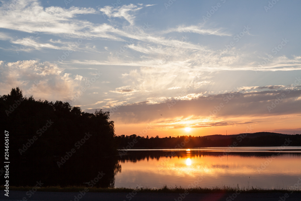 Sunset at lakeside serene summer evening