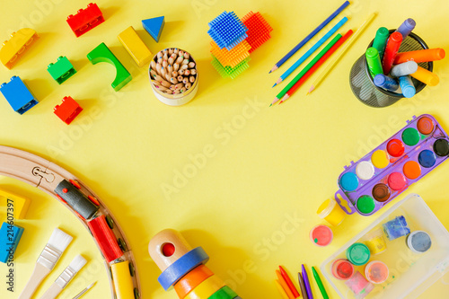 Day care concept - art supplies and toys on bright background