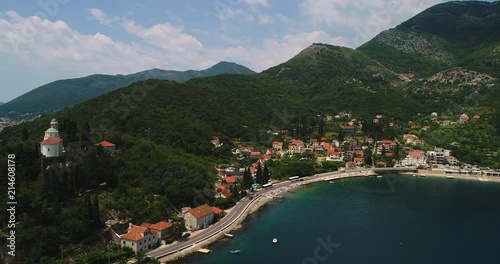 Aerial panoramic beautiful view from above to Kotor Bay and regular passenger ferry from Lepetane to Kamenari by a sunny afternoon photo