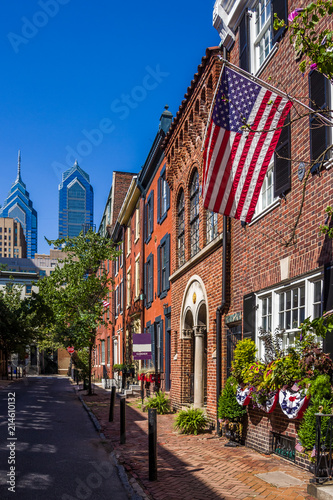 Scenic view at S Smedley Street in Philadelphia with traditional houses in the foreground and downtown buildings in the background photo