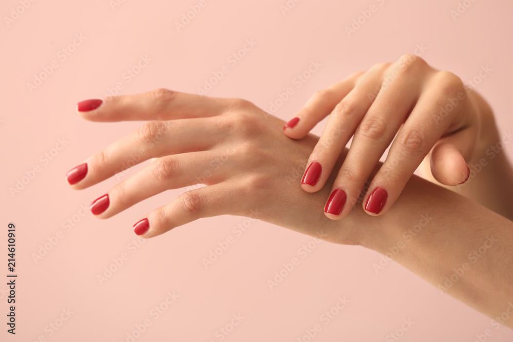Fototapeta premium Female hands with beautiful manicure on color background