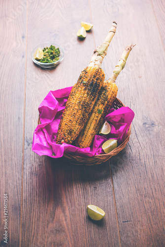 Delicious Indian street corn cob also called Bhutta, flavoured with spicy chilli, butter etc. Selective focus