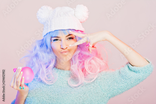Kawaii fashion young woman with pink and purple hair, posing, swearing pastel colors. Studio lighting, medium retouch.