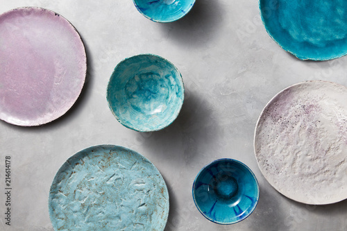 Vászonkép Set of porcelain handcraft plates or bowls on a gray table