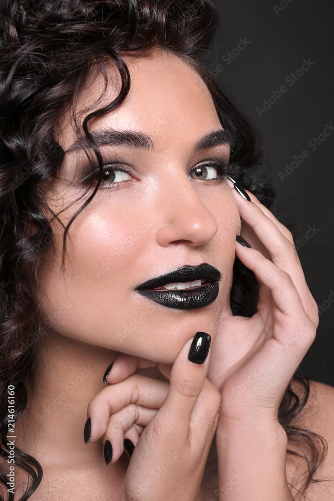 Fashionable young woman with black manicure on dark background, closeup Fashionable young woman with black manicure on dark background, closeup