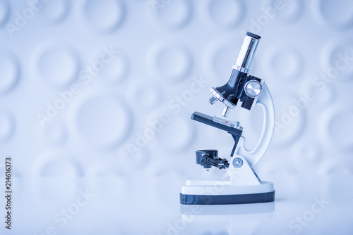 Microscope on table in Laboratory. Science chemistry concept. Blue tone