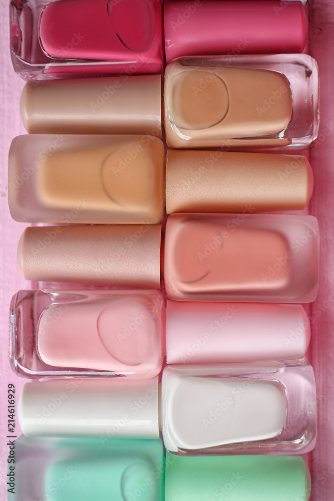 Bottles of colorful nail polishes on wooden background Bottles of colorful nail polishes on wooden background