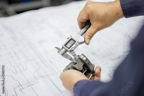 Engineering inspection check dimension automotive parts reference drawing by vernier caliper in factory