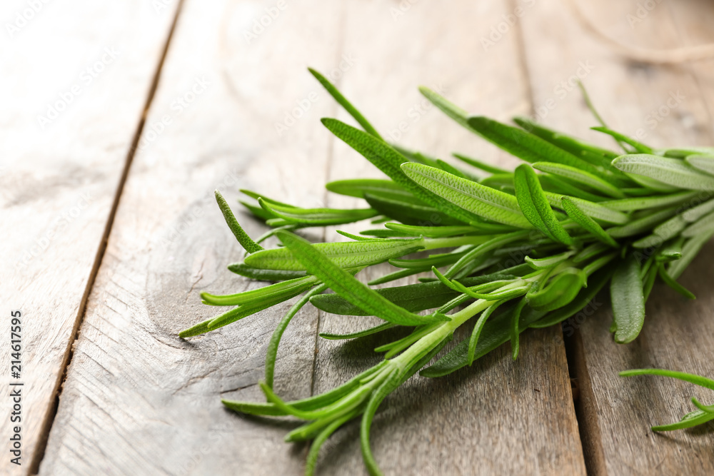 Fresh rosemary on wooden background, closeup Fresh rosemary on wooden background, closeup