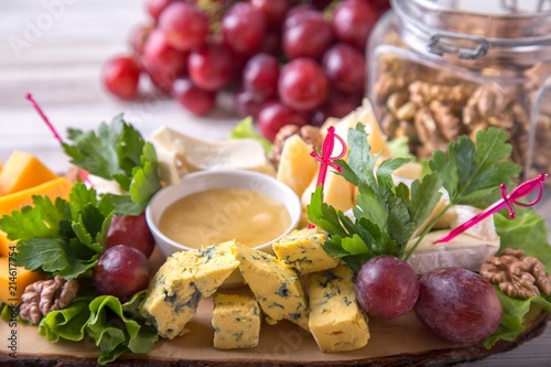 Cheese plate on wooden board. Tasty cold appetizer