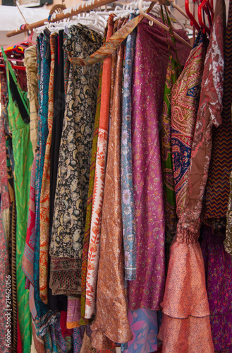 Many colorful clothes hanging for sale