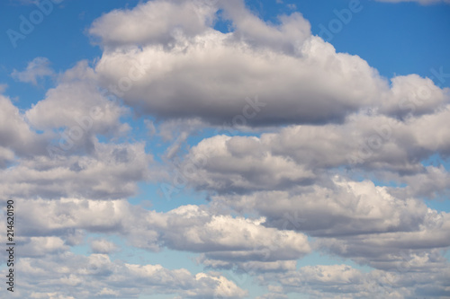 Clear blue sky background covered with lots of clouds. Vibrant nature scene