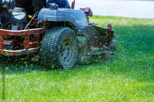 Red Lawn mower cutting grass. Gardening concept