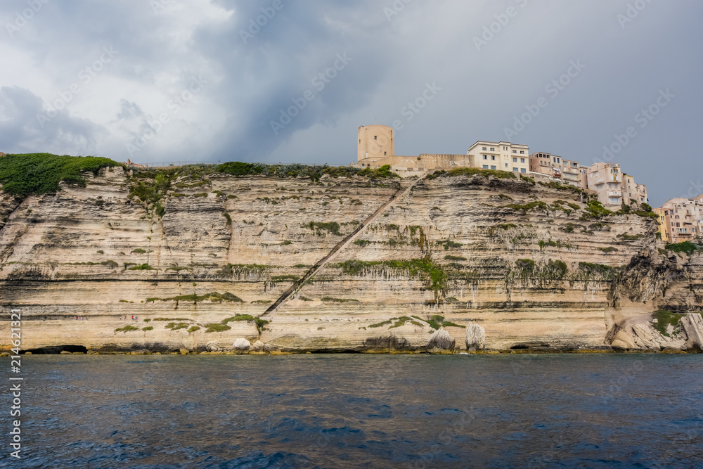 Stairs carved into the coastal rock leading to the city.