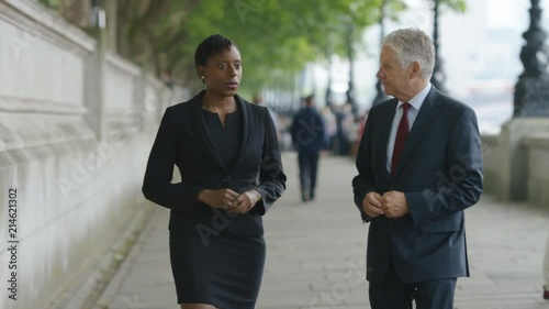 Journalist walking and interviewing a subject in the city