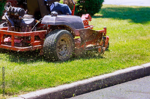 process of lawn mowing, concept of mowing the lawn, lawnmower cutting grass with gardening tools