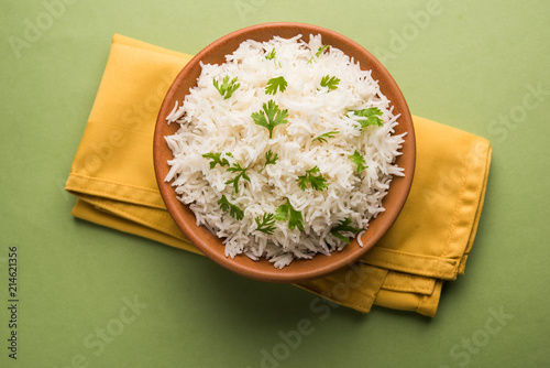 Coriander or cilantro Basmati Rice, served in a ceramic or terracotta bowl. It's a popular Indian OR Chinese recipe. Selective focus