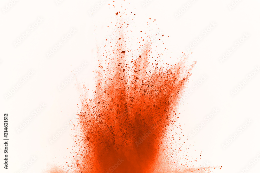 Orange powder explosion isolated on white background. Freeze motion of