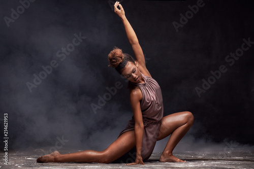 Young afro girl dancing, sensual pose.