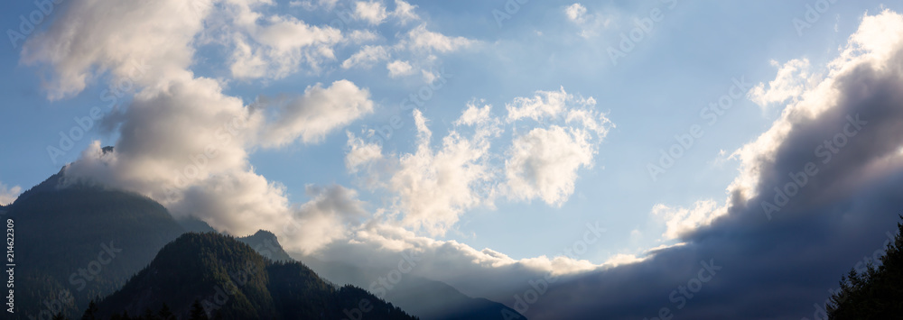 Panoramic view of the striking cloudy sky over the Canadian Mountain Landscape during a vibrant sunset. Taken in Hope, BC, Canada.