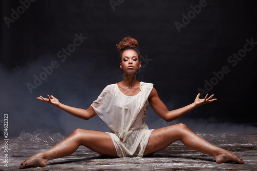 Young afro girl posing over water.