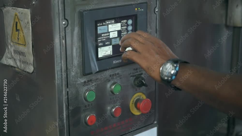 Asian Man Pressing Buttons On A Machine - Close Up Asian Man Pressing Buttons On A Machine - Close Up