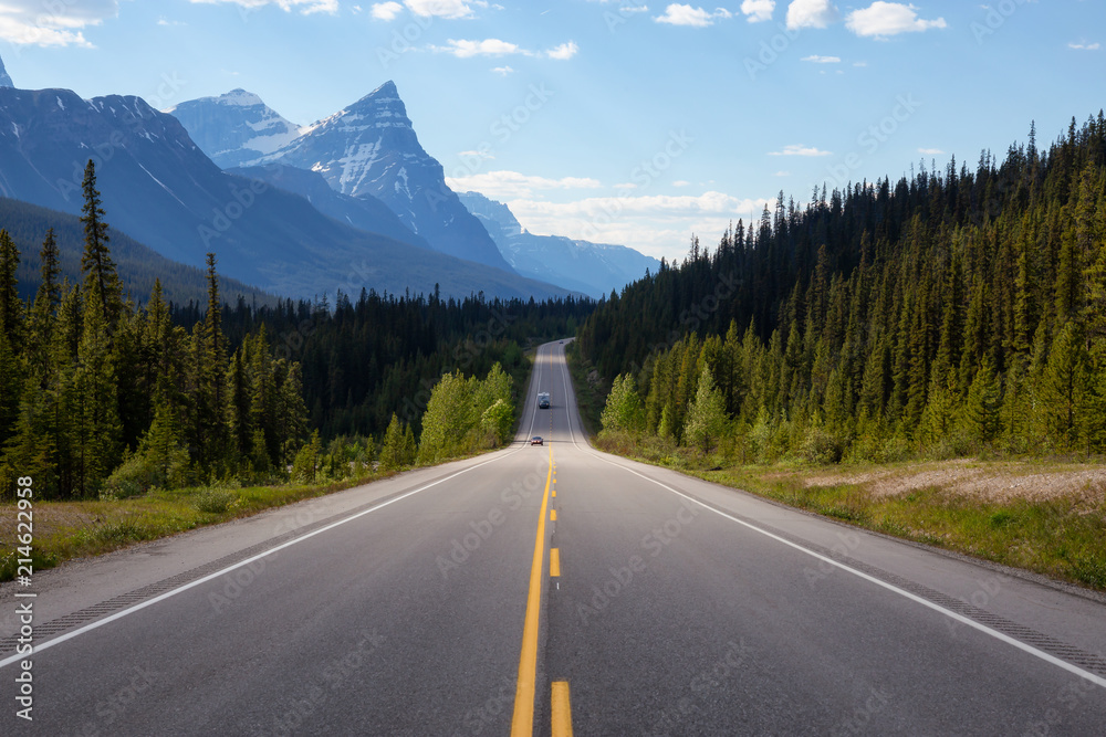 Scenic road in the Canadian Rockies during a vibrant sunny summer day. Taken in Icefields Parkway, Banff National Park, Alberta, Canada.