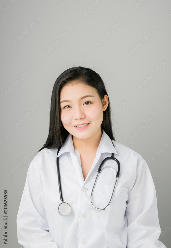 The women doctor stands and has stethoscope hanging on his neck. The women doctor stands and has stethoscope hanging on his neck.