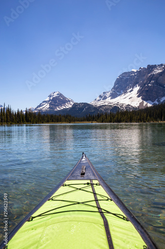 Kayaking in a glacier lake during a vibrant sunny summer day. Taken in Bow Lake, Banff National Park, Alberta, Canada. © edb3_16