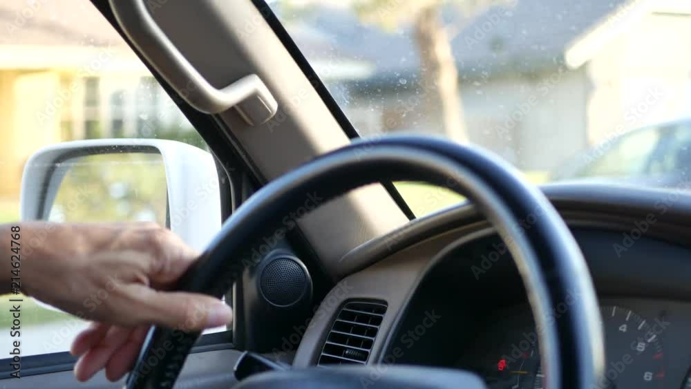 CLOSE UP A man's hands on steering wheel while driving a car. CLOSE UP A man's hands on steering wheel while driving a car.