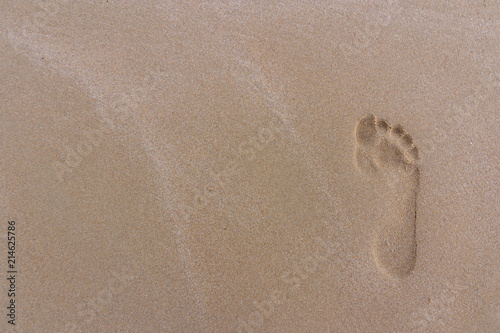 Close up footprints on sand beach in the morning during summer vacation,sand background