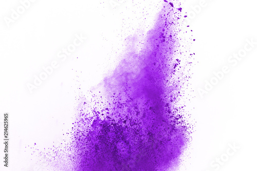 Abstract violet powder explosion. Closeup of violet dust particle splash isolated on white background