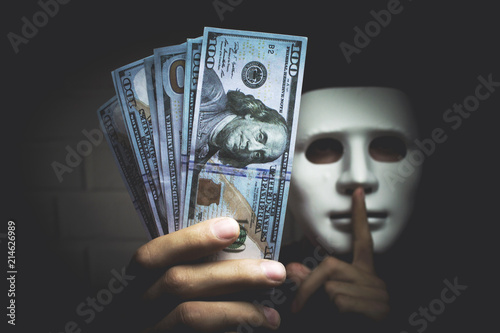 Bribery people with dollar bills in hand and quiet gesture photo