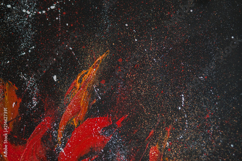 Red smears of orange paint on a black background