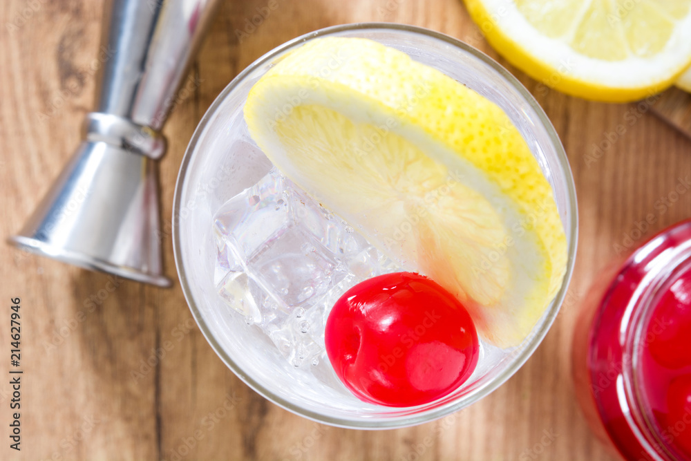 Classic Tom Collins cocktail on wooden table. Top view Classic Tom Collins cocktail on wooden table. Top view