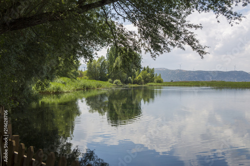 Summer nature landscape with beautiful clouds and lake in the forest