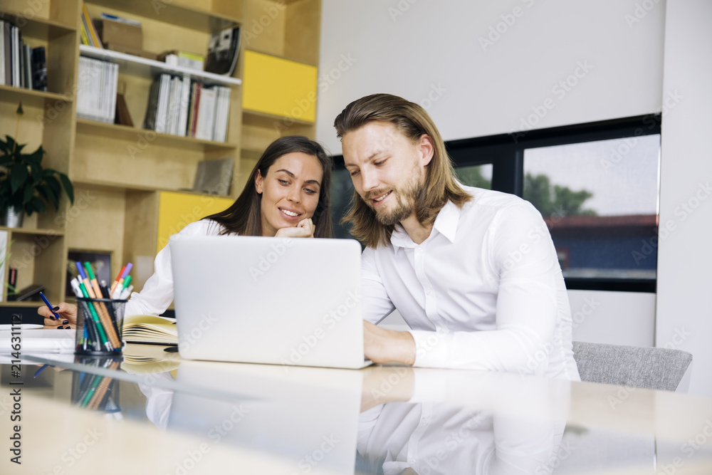 Business couple working together on project at modern startup office Business couple working together on project at modern startup office
