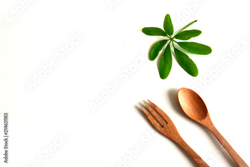 Wooden utensils on a white background spoon fork with leaf