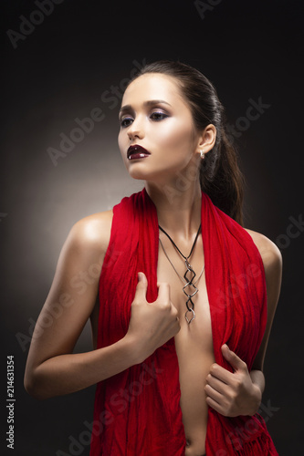 Beautiful brunette topless girl model, covering her naked breast with a red  scarf and wearing a modern necklace on the deep decollete. Stock Photo |  Adobe Stock