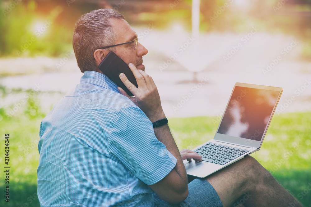 Businessman working outdoors with notebook Businessman working outdoors with notebook