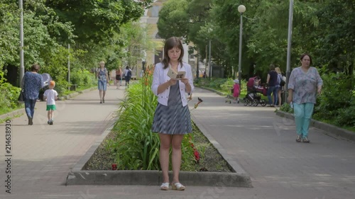 Girl reading a book in the park. Timelapse