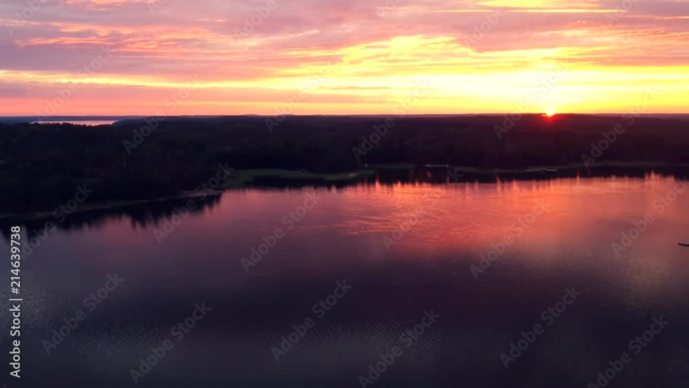 Panning shot of sunset setting over the sea and forest Panning shot of sunset setting over the sea and forest