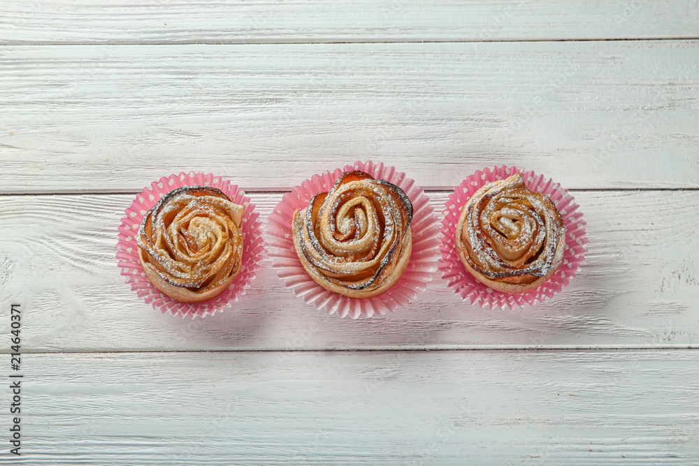 Rose shaped pastry with apple filling on table Rose shaped pastry with apple filling on table