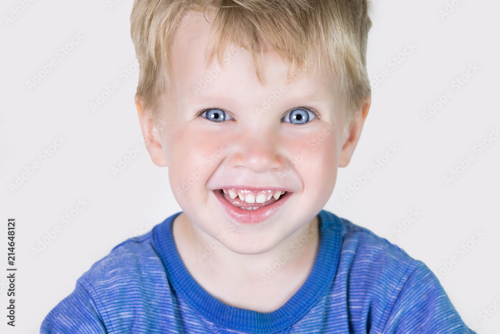 Three years old kid and emotions, close-up portrait of happy smiling child looking at camera at white background Three years old kid and emotions, close-up portrait of happy smiling child looking at camera at white background