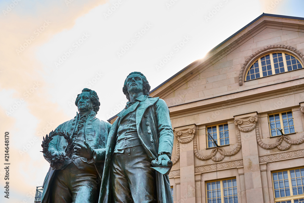 Obraz premium Famous sculpture of Goethe and Schiller in the city of Weimar in Germany / Most famous classical german authors / 18th century